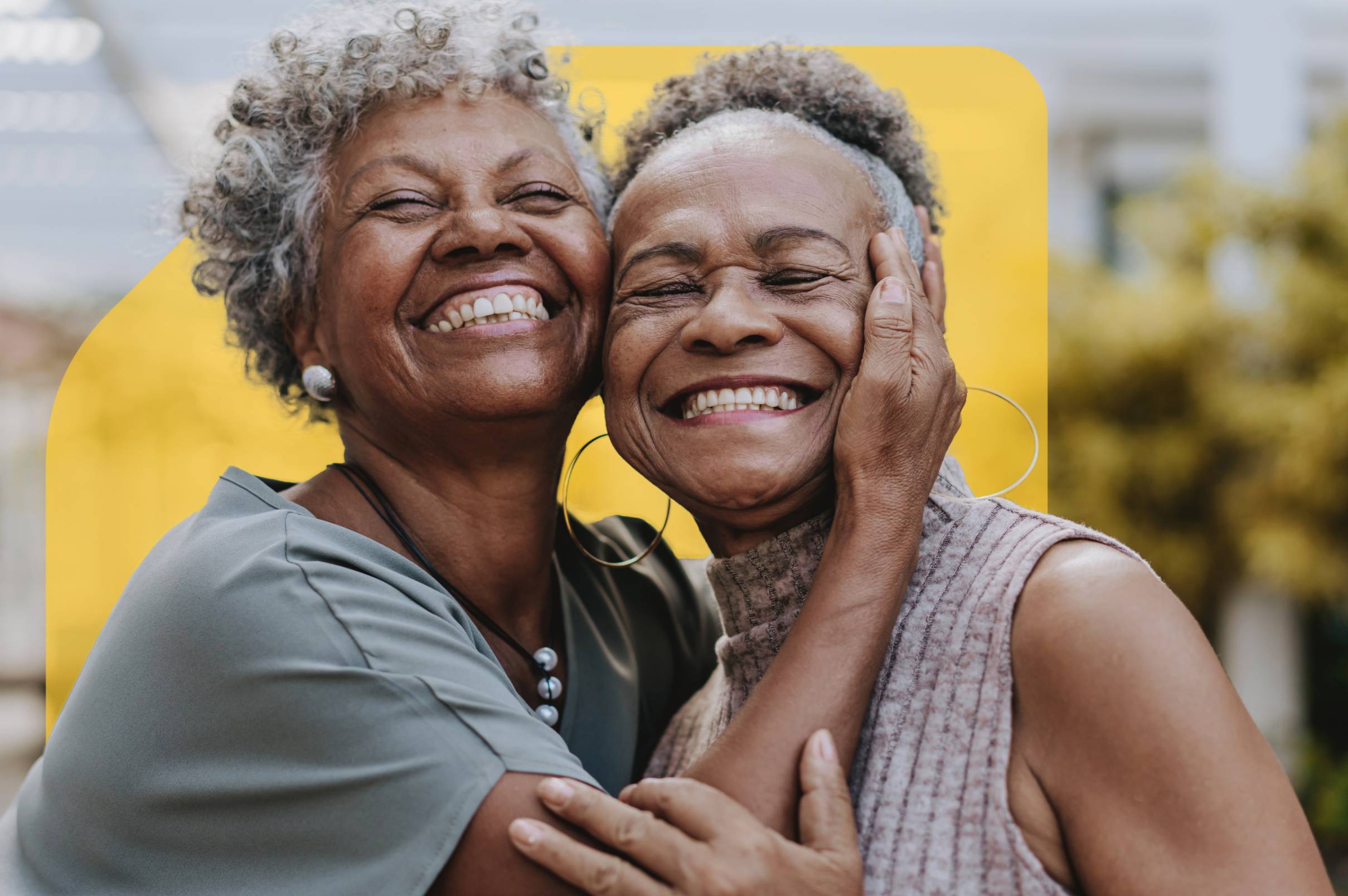 Two women joyfully embracing one another
